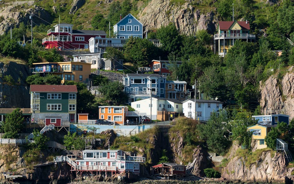 Vibrant houses perched on cliffs in St. John's, showcasing unique architecture and coastal charm.